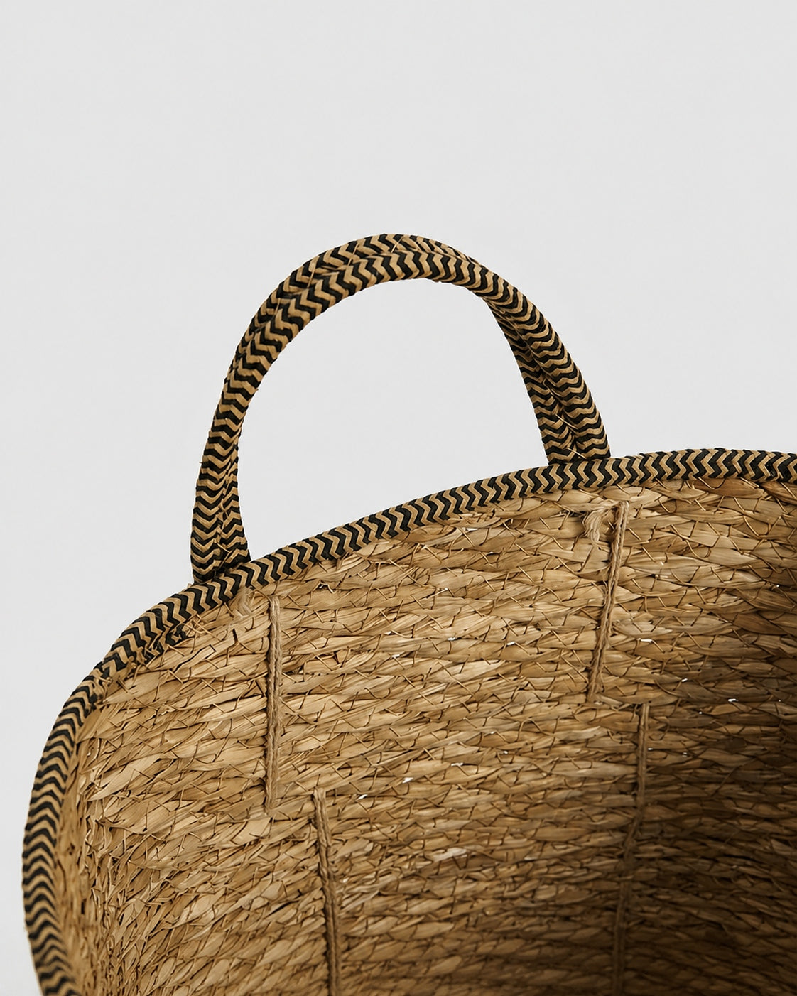 Handmade grass woven basket with natural carry handle detail