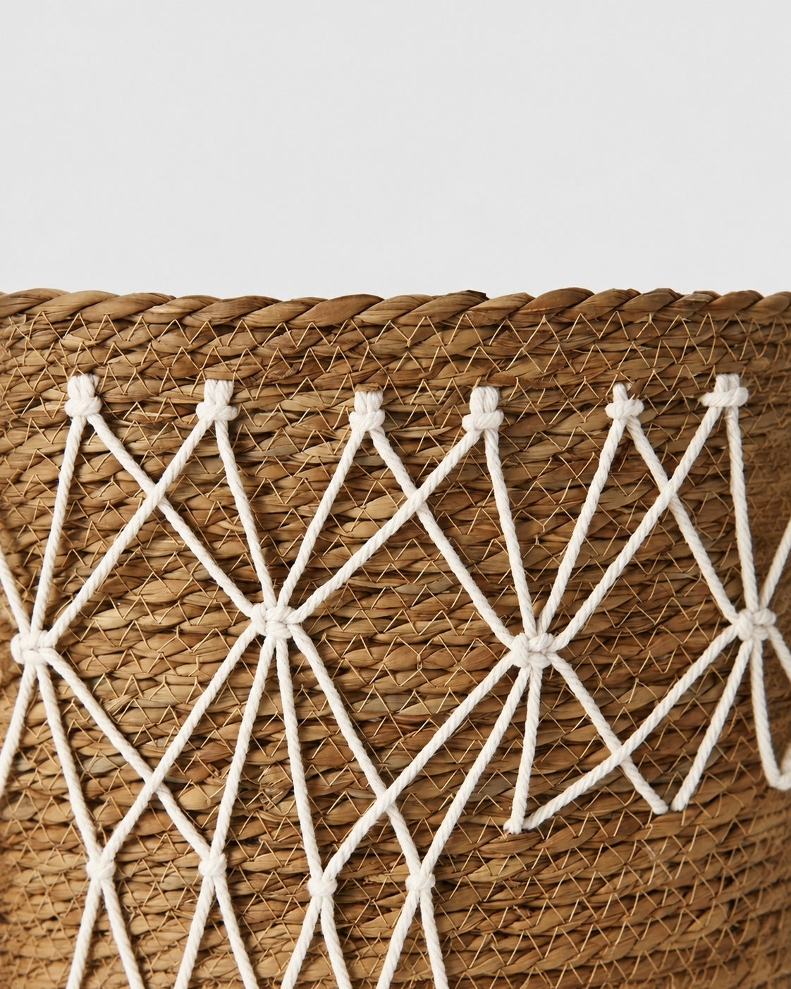 Decorative woven pattern on grass storage basket
