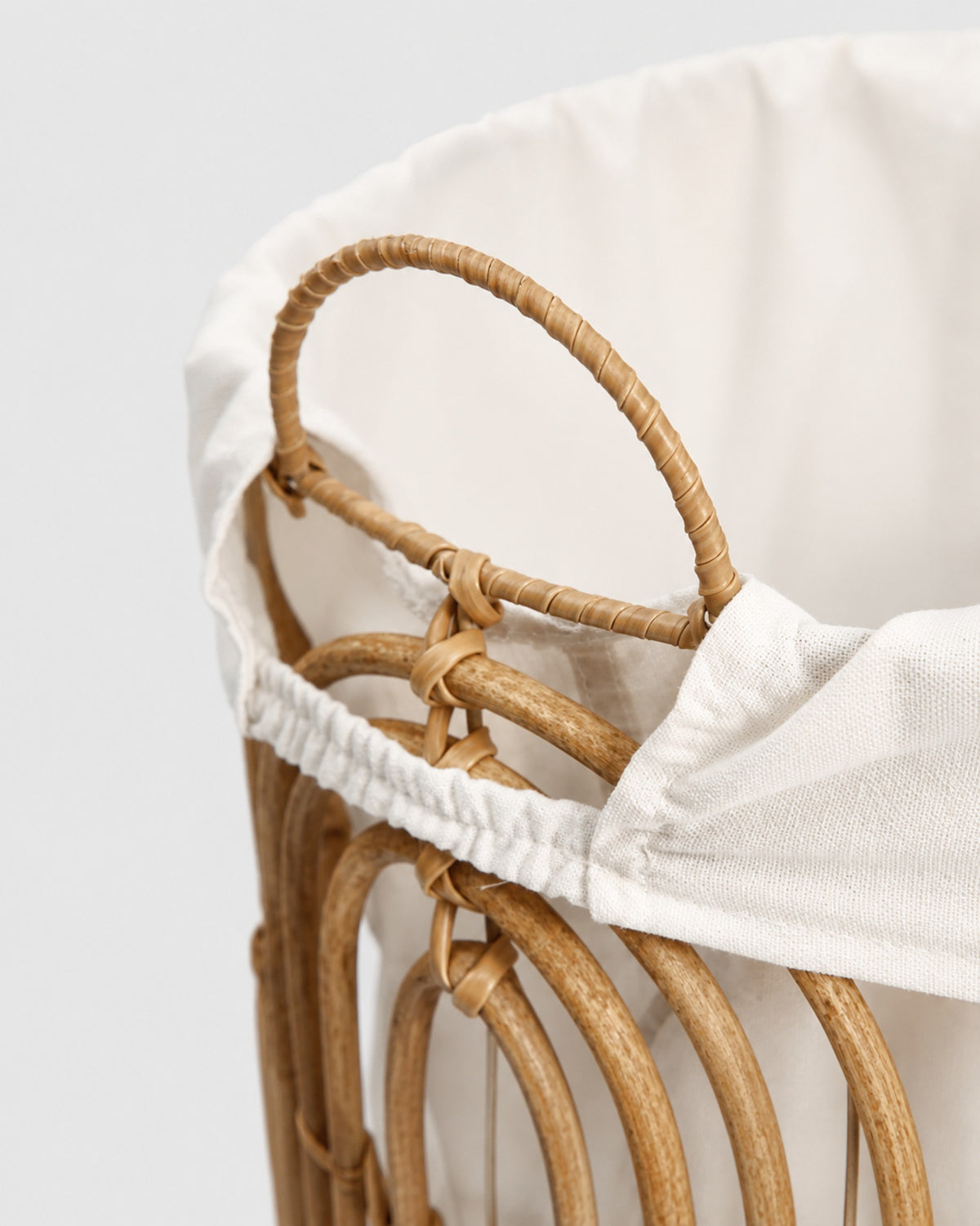 Close-up of Aveline basket’s faux rattan loop handle and gathered fabric liner