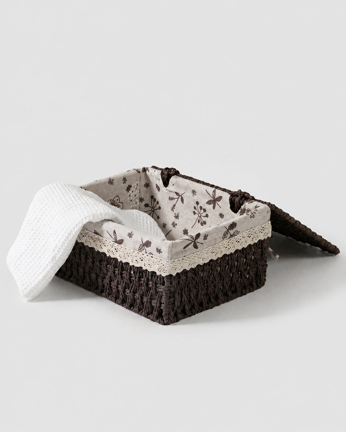 Dagny paper rope storage box opened to show floral fabric lining and towel storage