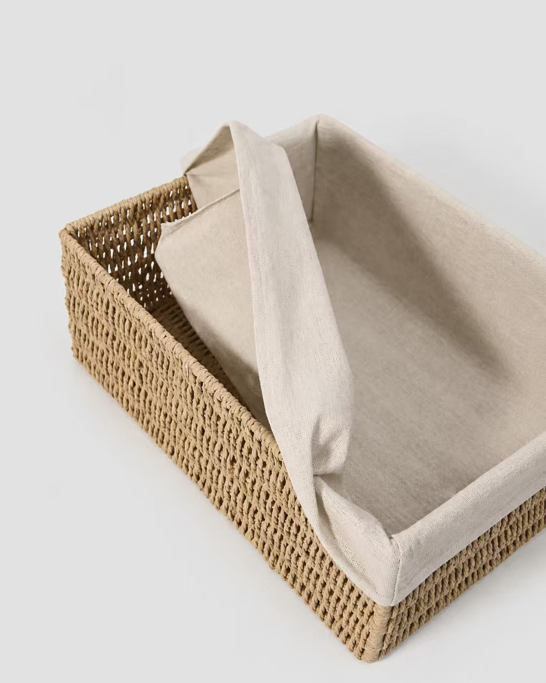 Close-up of Liv vanity basket’s natural paper rope weave and soft fabric liner