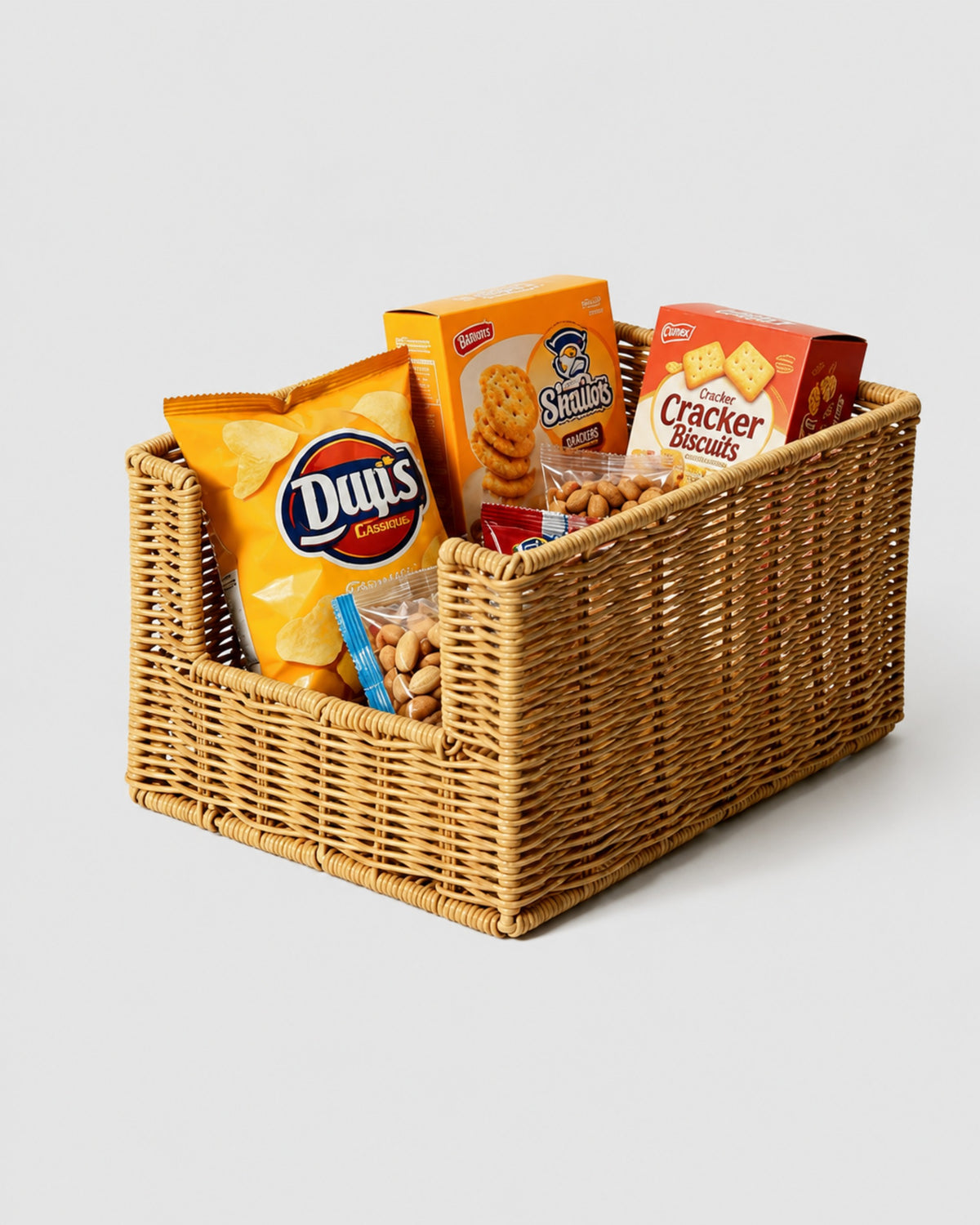 Mila natural faux rattan open-front snack basket holding packaged crisps, crackers and nuts