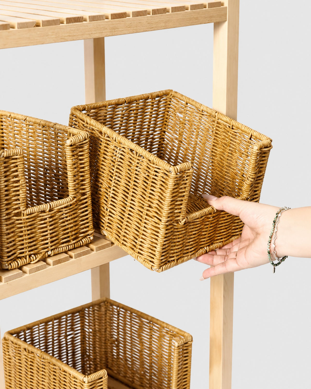 Mila faux rattan open-front snack baskets arranged on a wooden storage shelf