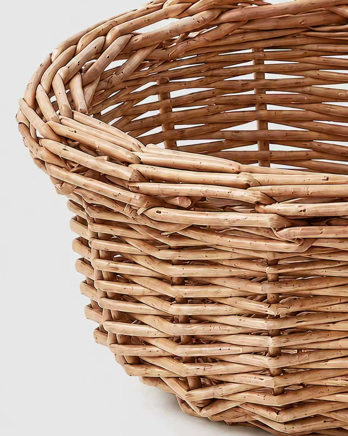 Close-up of Mona faux rattan fruit basket’s open woven rim and tapered side detail