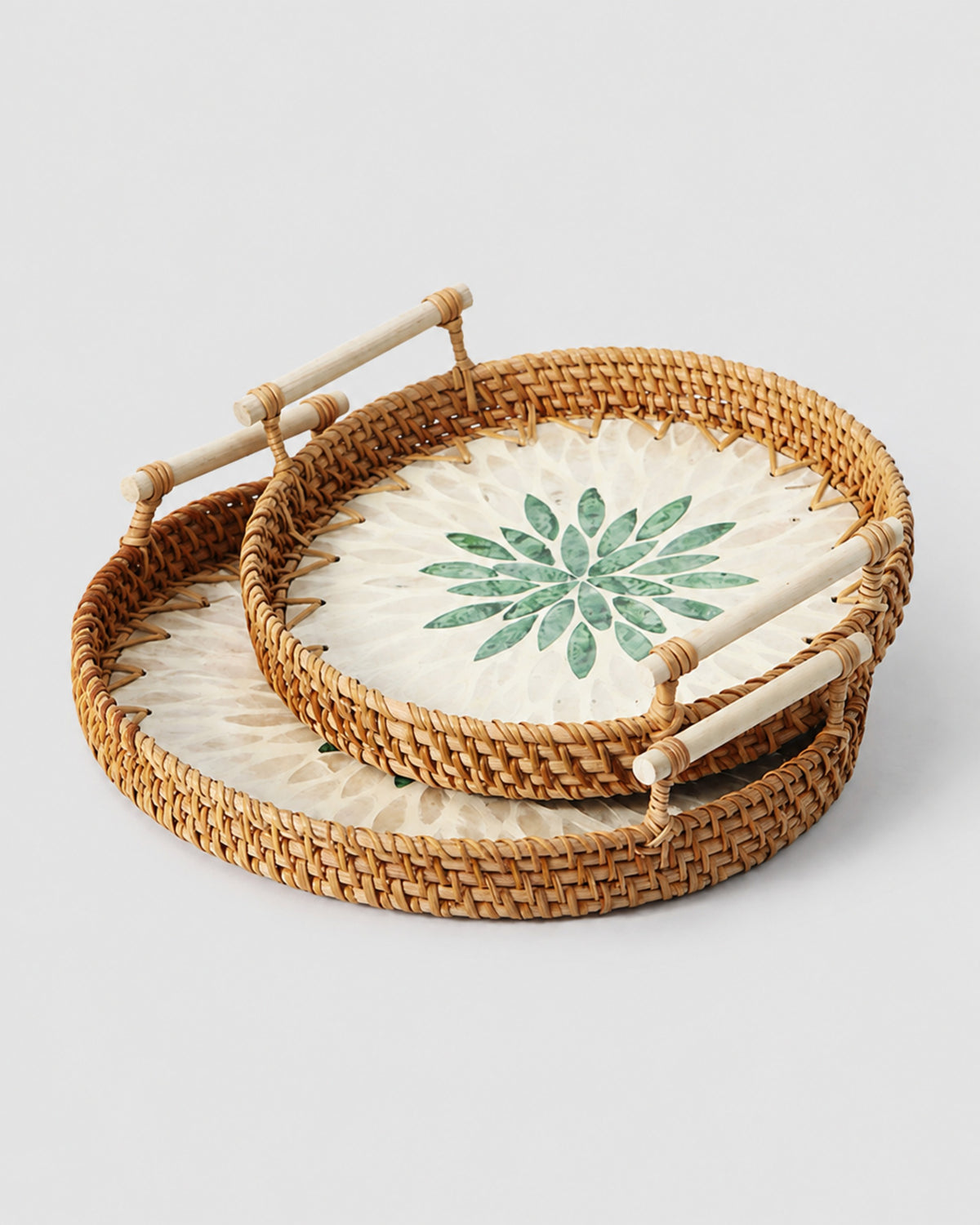 Small, Medium and Large Signe handwoven rattan serving trays with green leaf-motif centres