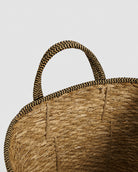 Handmade grass woven basket with natural carry handle detail