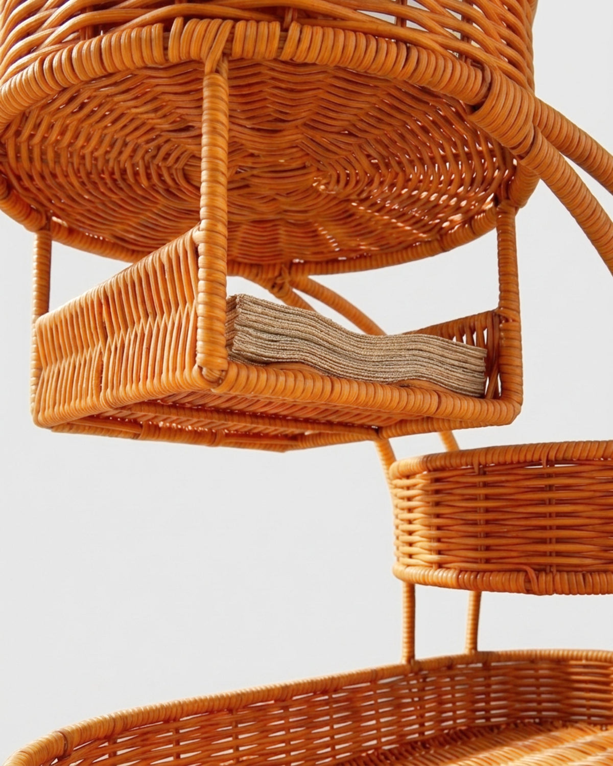Close-up of Algot stand’s integrated faux rattan tissue holder and woven tier supports