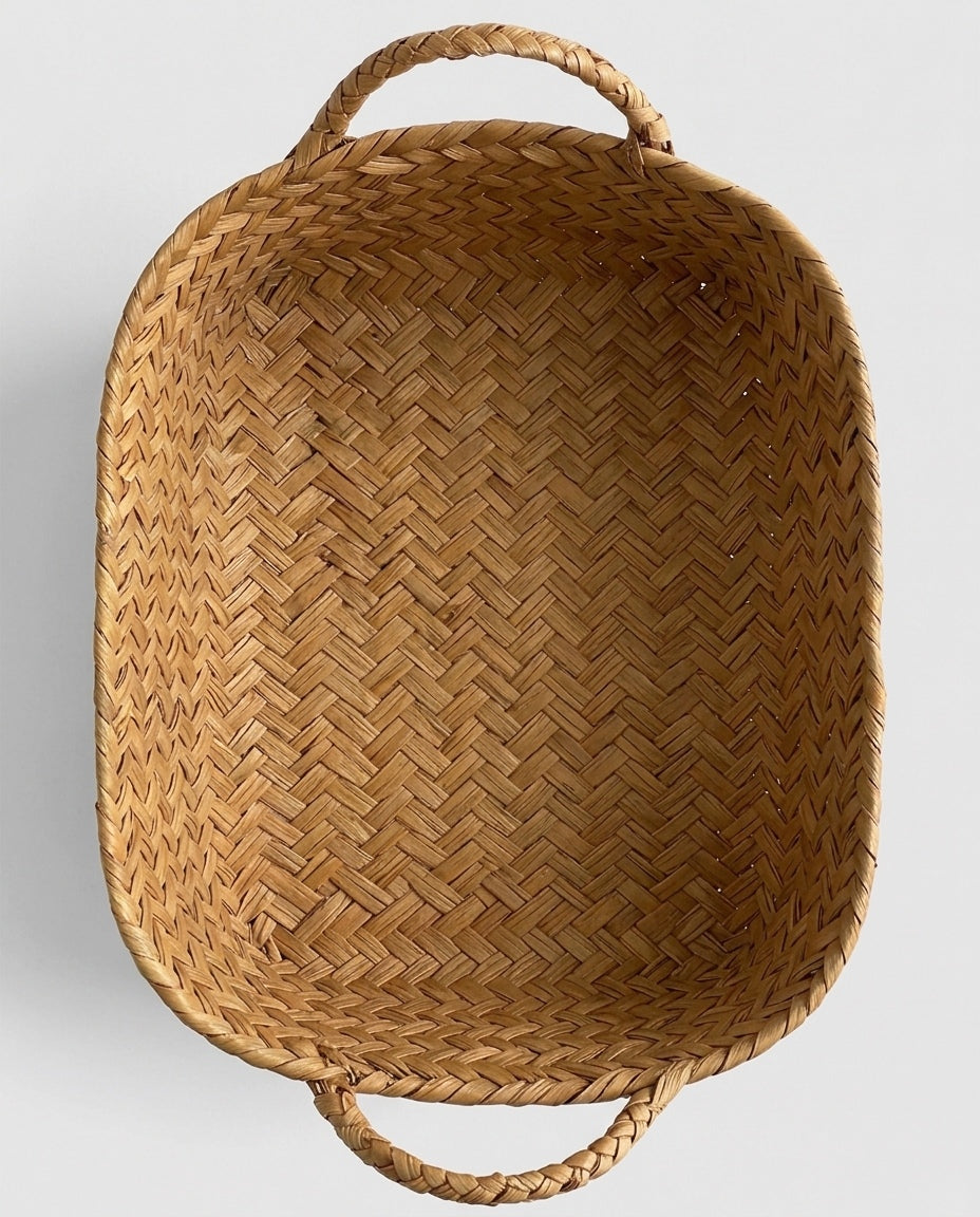 Top view of Birgit grass woven storage basket with two loop handles
