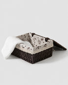 Dagny paper rope storage box opened to show floral fabric lining and towel storage