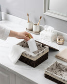 Dagny lidded paper rope storage box organising bath products and a towel on a bathroom vanity