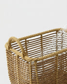 Detailed view of Edda faux rattan basket’s open horizontal weave and structured corner