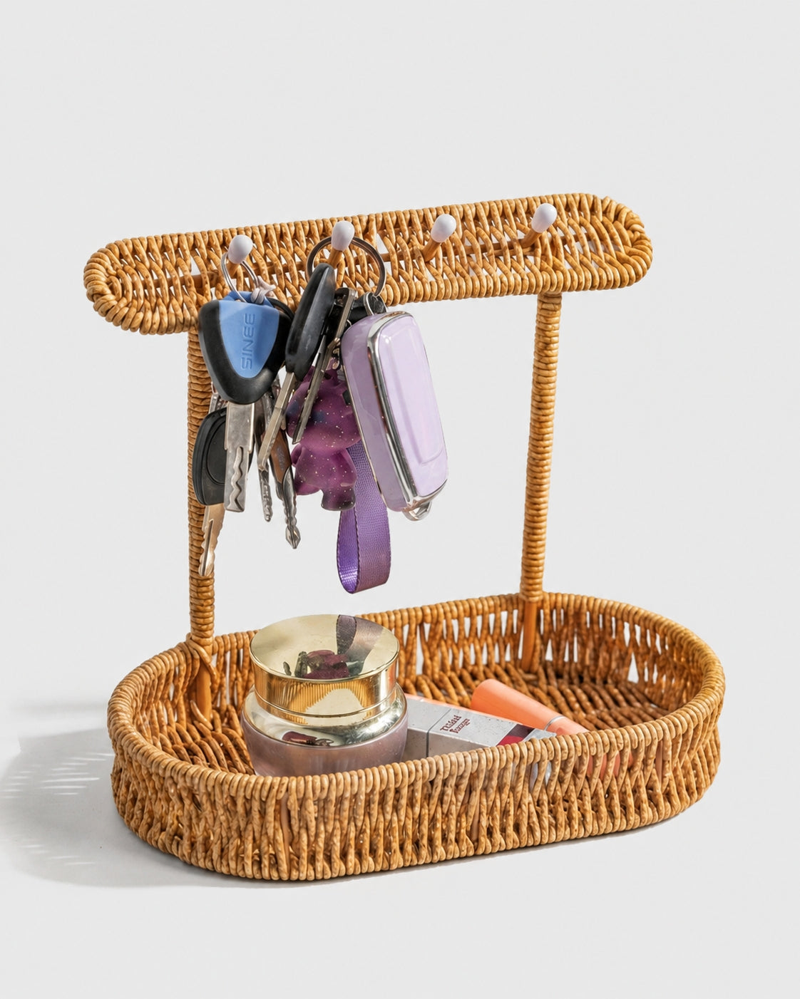 Einar faux rattan key holder with four hooks and a catchall tray holding keys and small items