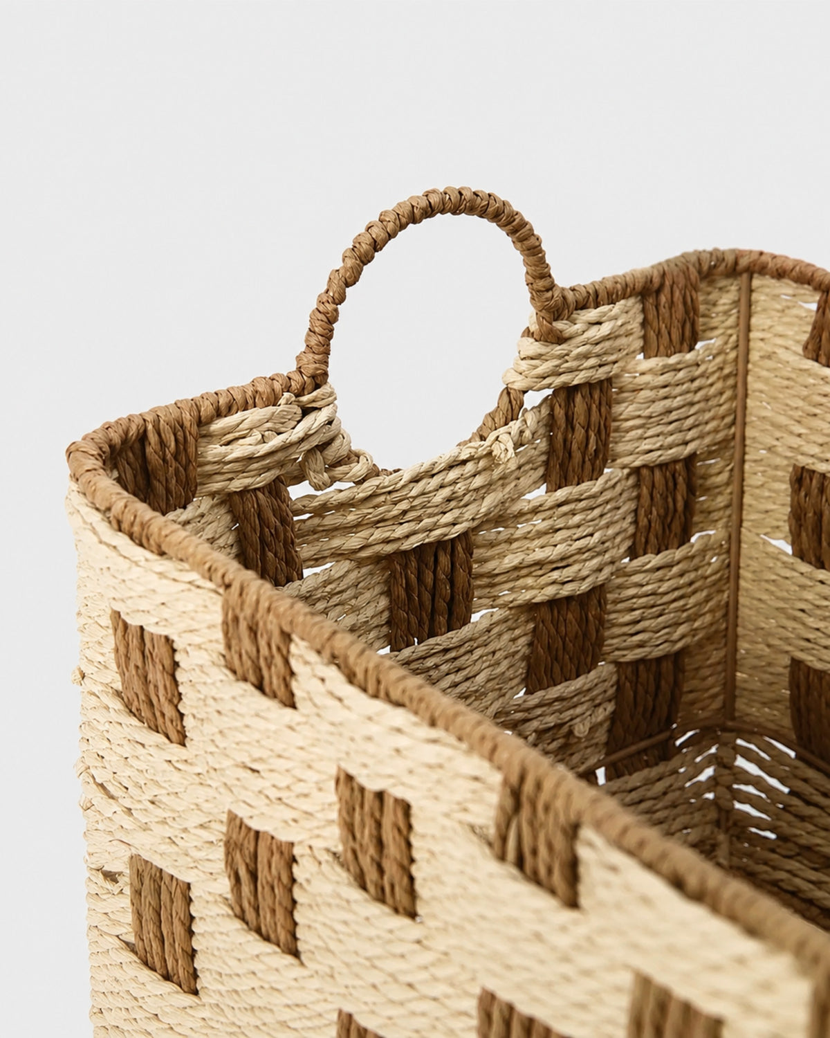 Close-up of Elsa basket’s handwoven paper rope handle and two-tone woven rim