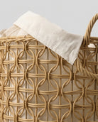 Close-up of Esme faux rattan loop weave, natural fabric liner and braided handle