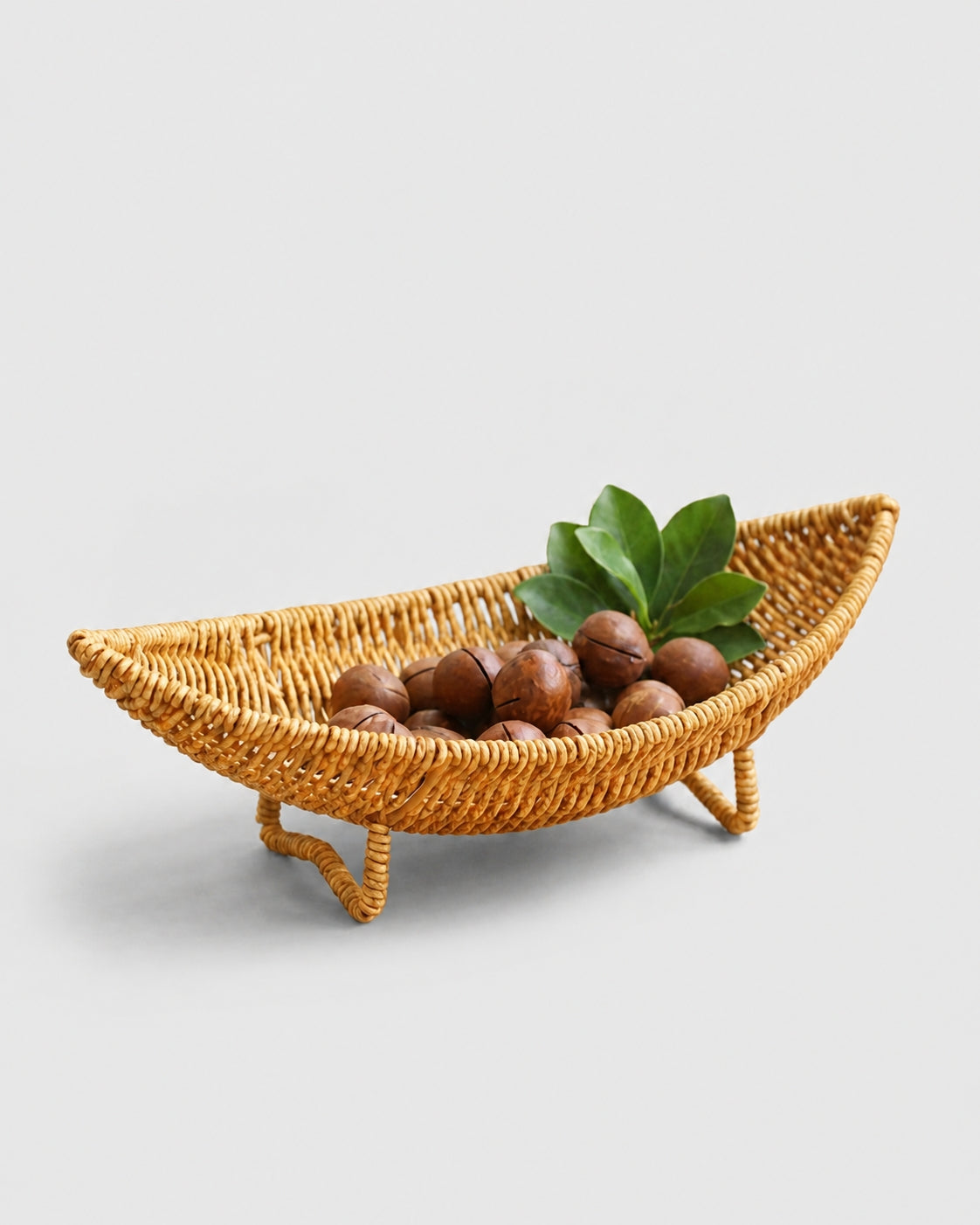 Haldor raised faux rattan fruit bowl with a curved boat shape and four woven feet