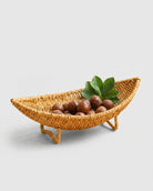 Haldor raised faux rattan fruit bowl with a curved boat shape and four woven feet