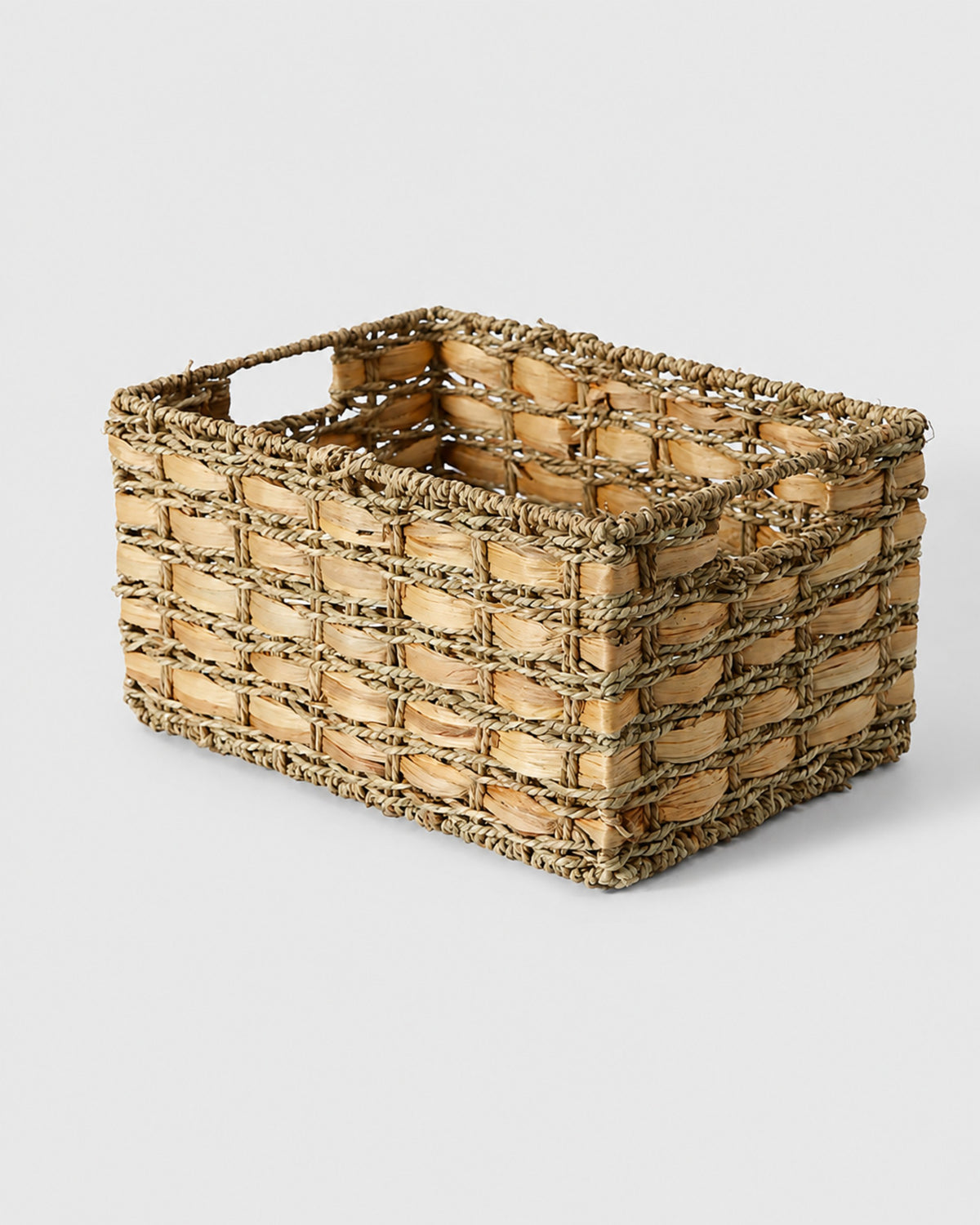 Inga handwoven natural grass desktop storage basket with integrated side handles