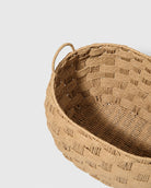 Close-up of Kari basket’s natural paper rope interior, wrapped rim and loop handle