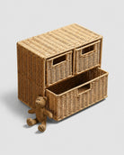 Mikkel faux rattan three-drawer storage cabinet with one lower drawer open