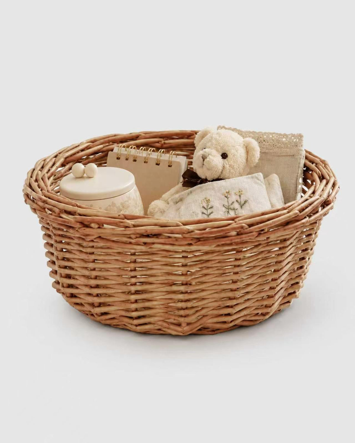Mona faux rattan storage basket holding small household items and accessories