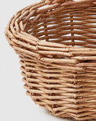 Close-up of Mona faux rattan fruit basket’s open woven rim and tapered side detail