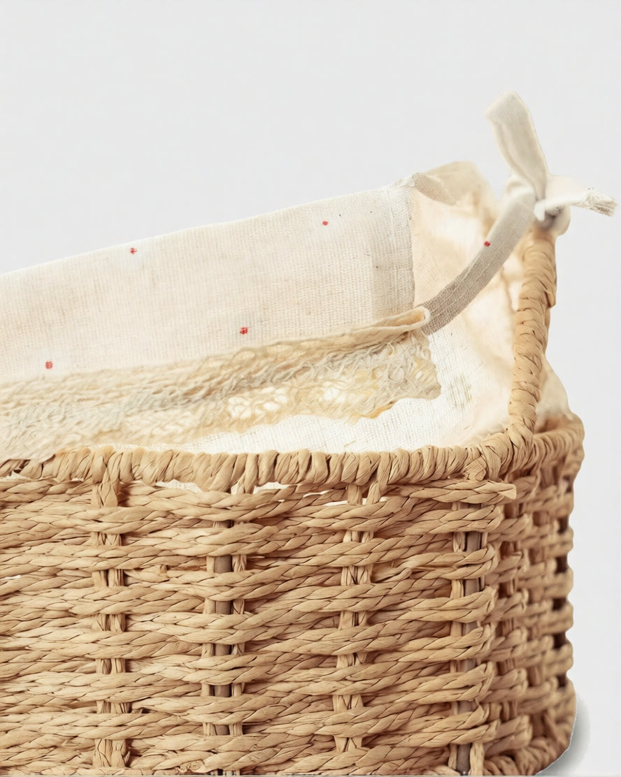 Close-up of Rakel basket’s handwoven paper rope body, daisy-patterned lining and lace trim