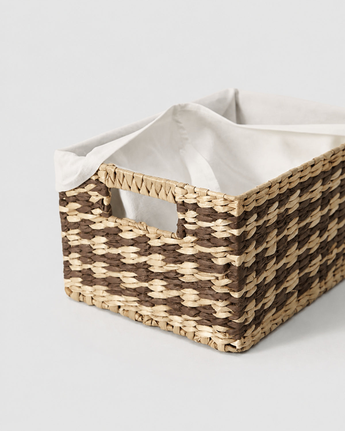 Close-up of Sofia basket’s integrated cutout handle and fabric liner