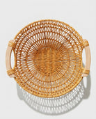 Top view of Viggo round faux rattan basket with open weave and two side handles