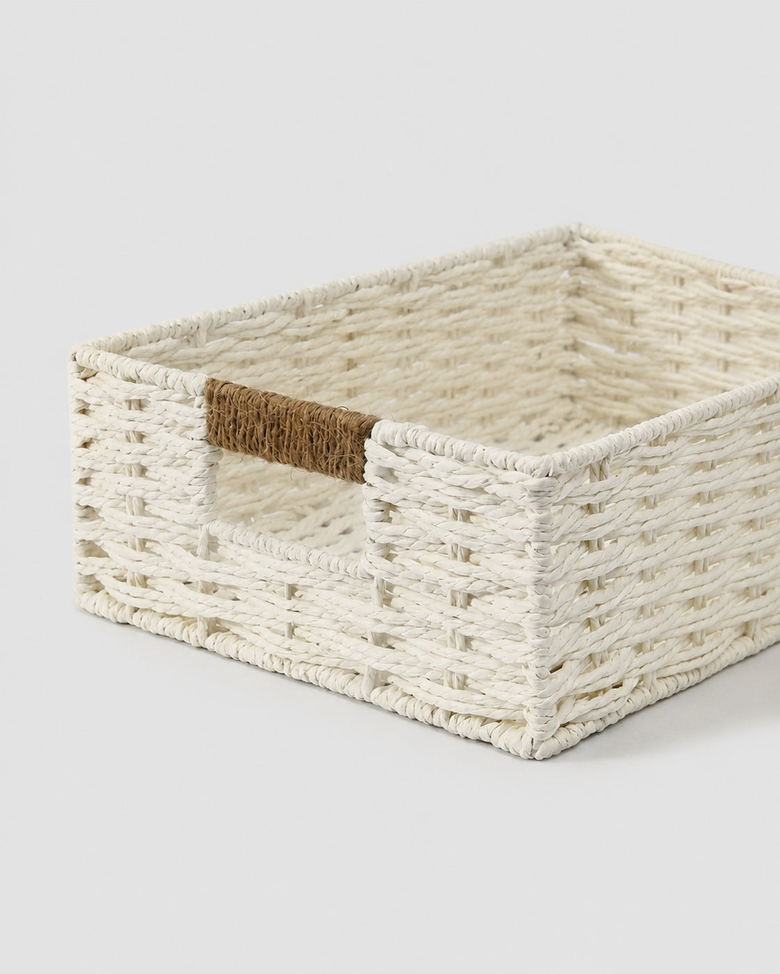 Handmade white woven basket with easy carry handle detail