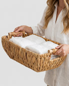Natural woven basket with handles for towels and bathroom essentials storage