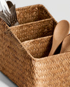 Grass woven basket organizer holding kitchen tools and utensils