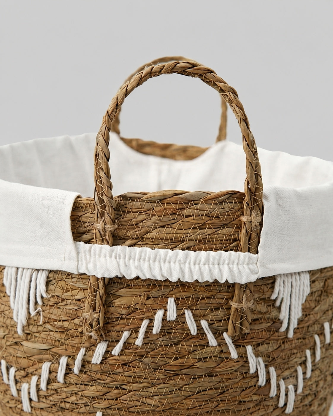 Handmade woven laundry basket handle detail for easy carrying