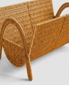 Woven rattan magazine rack side view with natural handmade design